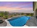 Beautiful pool with a rock waterfall feature and a mountain view at 5724 E Scarlet St, Mesa, AZ 85215