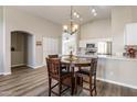 Cozy dining area adjacent to the kitchen, featuring a chandelier and a view of the living space at 635 S Lanus Dr, Gilbert, AZ 85296