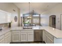 Open kitchen overlooks living area, with stainless appliances and quartz countertops at 635 S Lanus Dr, Gilbert, AZ 85296