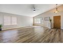 Bright living room features hardwood floors, large windows, ceiling fan and neutral paint palette at 635 S Lanus Dr, Gilbert, AZ 85296