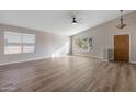 Spacious living room with vaulted ceilings, ceiling fan and wood-look flooring at 635 S Lanus Dr, Gilbert, AZ 85296