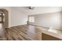 Spacious living room boasts hardwood floors and multiple windows offering plenty of natural light at 635 S Lanus Dr, Gilbert, AZ 85296