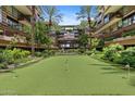 This property features a putting green, palm trees, a water feature, and lush landscaping at 7117 E Rancho Vista Dr # 3010, Scottsdale, AZ 85251