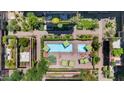 Aerial view of the community pool, featuring lounge chairs, umbrellas and lush landscaping at 7117 E Rancho Vista Dr # 3010, Scottsdale, AZ 85251
