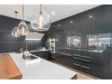 Modern kitchen featuring white countertops, gray cabinets, and decorative pendant lighting at 7180 E Kierland Blvd # 1116, Scottsdale, AZ 85254