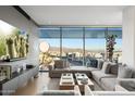 This expansive living room offers city views and a modern entertainment center with a beautiful cactus print display at 7180 E Kierland Blvd # 1116, Scottsdale, AZ 85254