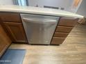 Stainless steel dishwasher integrated into wooden cabinets, complemented by neutral countertops and flooring at 903 W Jacinto Cir, Mesa, AZ 85210