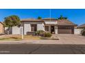 Attractive single-level home with a well-maintained yard and a two-car attached garage at 10529 E Posada Ave, Mesa, AZ 85212