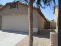Side view of a home's two car garage with desert landscaping at 12425 W Montebello Ave, Litchfield Park, AZ 85340