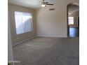 Spacious living room with neutral carpet and natural light streaming in from windows at 12425 W Montebello Ave, Litchfield Park, AZ 85340
