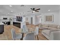 Open-concept living area featuring modern furnishings, hardwood floors, and an adjacent kitchen with a large island at 13224 N 31St Pl, Phoenix, AZ 85032