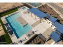 Overhead shot of a community pool area with a large pool, hot tub, and covered lounge area with seating at 15883 W Winslow Ave, Goodyear, AZ 85338