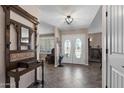 Inviting foyer with tile flooring, coat rack, stained glass double doors, and neutral decor at 1753 Leisure World --, Mesa, AZ 85206