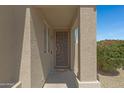 Inviting covered front entry featuring a stylish security door and well-maintained landscaping at 1821 S Navajo Way, Chandler, AZ 85286