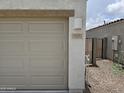 Close-up of the garage with house number, exterior lighting, and gated side yard at 18361 E Eloisa Dr, Gold Canyon, AZ 85118