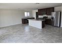 Open-concept kitchen featuring stainless steel appliances and a large island for entertaining at 18361 E Eloisa Dr, Gold Canyon, AZ 85118