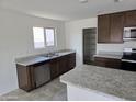 Well-lit kitchen with stainless steel appliances, granite countertops, and a walk-in pantry at 18361 E Eloisa Dr, Gold Canyon, AZ 85118