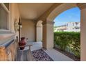 Covered porch features a wooden bench, patterned rug, and stucco columns at 20699 W Ridge Rd, Buckeye, AZ 85396