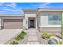 Inviting front entrance with desert landscaping, neutral colors, and stone accents at 22218 N 28Th St, Phoenix, AZ 85050
