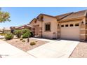 Exterior shot of home featuring desert landscaping, a tile roof, and an attached two-car garage at 2250 E Deer Valley Rd # 96, Phoenix, AZ 85024