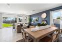 Bright living and dining area featuring tile floors, recessed lighting, modern decor, and large windows with backyard views at 2255 W Sheridan Ave, Apache Junction, AZ 85120