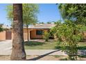 Single-story home with landscaping, a lawn, and mature trees in the front yard at 2636 N Dayton St, Phoenix, AZ 85006