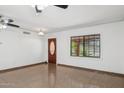 Bright living space with tile floors, a ceiling fan, front door, and a window at 2636 N Dayton St, Phoenix, AZ 85006