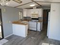 This kitchen features white appliances and cabinets with a breakfast bar, providing a cozy space for cooking at 2656 N 56Th St # C160, Mesa, AZ 85215