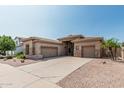 Attractive desert home featuring a low maintenance yard and attached garages at 371 W Indigo Dr, Chandler, AZ 85248