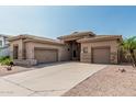 Stunning single-story home with desert landscaping, neutral stucco and stone accents with a two-car garage at 371 W Indigo Dr, Chandler, AZ 85248