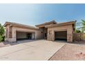 Spacious three-car garage with ample storage and a large driveway at 371 W Indigo Dr, Chandler, AZ 85248