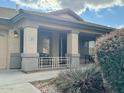 Inviting front porch with decorative columns and seating area, perfect for relaxing outdoors at 3891 E Simpson Rd, Gilbert, AZ 85297