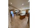 Open concept kitchen with tile flooring, stainless steel appliances, large island, and breakfast bar, providing ample cooking space at 3891 E Simpson Rd, Gilbert, AZ 85297