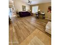 Cozy living room with hardwood floors, a comfortable sofa, and ample natural light at 3891 E Simpson Rd, Gilbert, AZ 85297