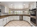 Bright kitchen featuring white cabinets, granite countertops, and stainless steel appliances at 400 W Crofton St, Chandler, AZ 85225