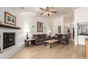 Spacious living room with fireplace, ceiling fan and hardwood floors at 400 W Crofton St, Chandler, AZ 85225