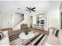 Bright living room featuring wood floors, modern furnishings, ceiling fan, and an open concept kitchen at 4229 E Betsy Ln, Gilbert, AZ 85296