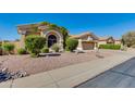Well-maintained front yard with desert landscaping and a view of neighboring homes in a suburban setting at 4511 E Kirkland Rd, Phoenix, AZ 85050