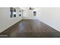 Bright, empty room with modern flooring, a ceiling fan and plenty of natural light from the windows at 4990 E Odessa Dr, San Tan Valley, AZ 85140