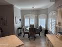 Bright dining room with modern chandelier, shuttered windows, neutral paint, and wood look flooring at 5335 E Shea Blvd Blvd # 2095, Scottsdale, AZ 85254