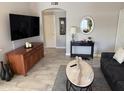 Spacious living room with a large TV, modern decor, wood look flooring, and plenty of natural light at 5335 E Shea Blvd Blvd # 2095, Scottsdale, AZ 85254