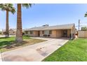 This charming home features mature landscaping and a covered carport for added convenience at 6255 E Rose Circle Dr, Scottsdale, AZ 85251