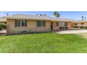 Well maintained single-story home with a mature, green front lawn at 6255 E Rose Circle Dr, Scottsdale, AZ 85251