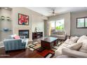 Inviting living room boasts a fireplace, stylish furnishings, and a sliding glass door to a private balcony at 6745 N 93Rd Ave # 1129, Glendale, AZ 85305