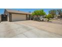 View of the home's exterior and driveway, showing the two-car garage and 'Beware of Dog' sign at 6802 S 47Th St, Phoenix, AZ 85042