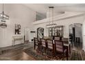 Spacious dining area featuring wood floors, a decorative rug and open access to the living areas at 735 W Kelton Ln, Phoenix, AZ 85023