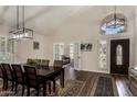 Elegant dining room with high ceilings, decorative rug and stylish light fixtures at 735 W Kelton Ln, Phoenix, AZ 85023