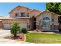 Charming two-story home featuring a three-car garage, manicured lawn and decorative stone accents at 735 W Kelton Ln, Phoenix, AZ 85023