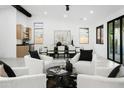 Bright living room with modern furnishings, views into the dining and kitchen areas at 7774 E San Fernando Dr, Scottsdale, AZ 85255