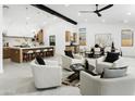 Open-concept living room with high ceilings, modern furnishings, adjacent to the dining and kitchen areas at 7774 E San Fernando Dr, Scottsdale, AZ 85255